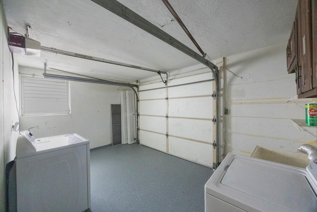 garage featuring washing machine and dryer and a garage door opener