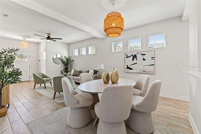 dining space with baseboards, visible vents, a ceiling fan, beamed ceiling, and wood tiled floor