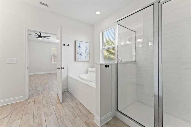 full bath featuring a bath, a shower stall, visible vents, and a wealth of natural light