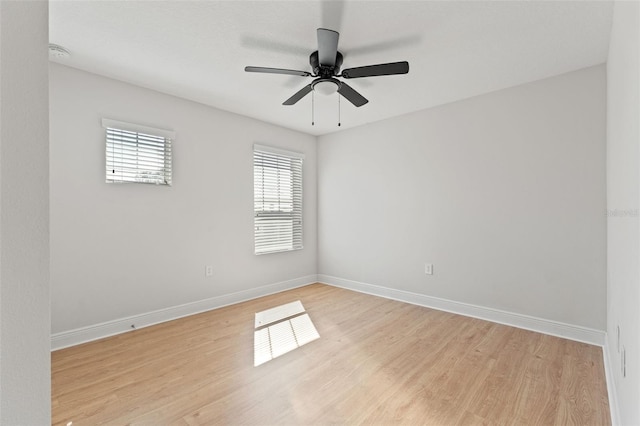 unfurnished room with light wood-style floors, ceiling fan, and baseboards