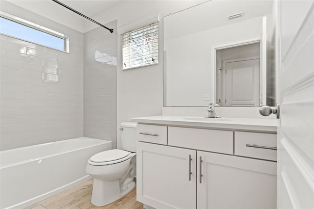 full bath with shower / washtub combination, visible vents, toilet, vanity, and wood finished floors