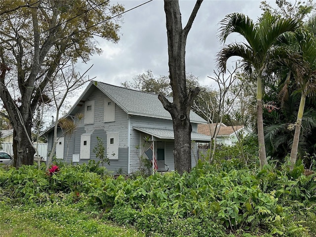 view of side of home featuring a shingled roof