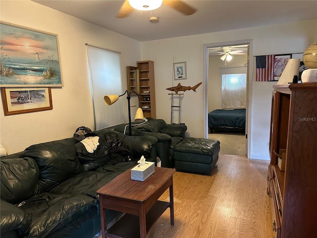 living area featuring light wood finished floors and a ceiling fan