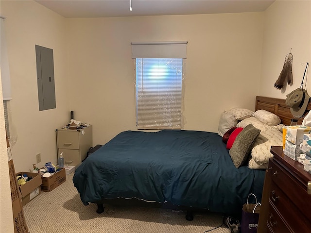 bedroom featuring electric panel and light colored carpet