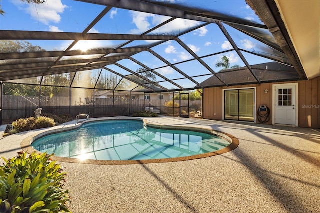 view of swimming pool featuring a patio area, fence, a fenced in pool, and a lanai