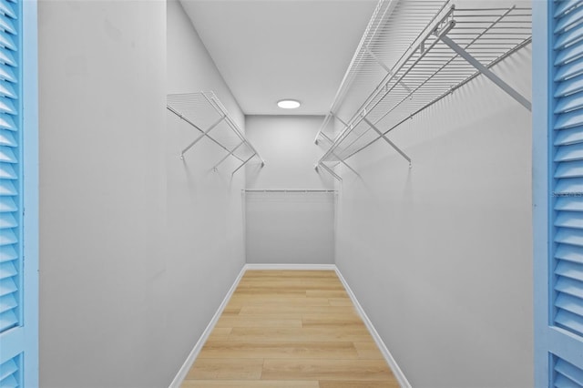 spacious closet with wood finished floors