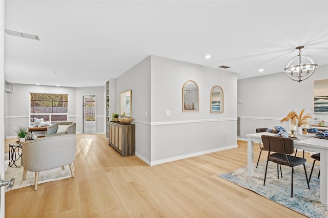 dining space featuring a notable chandelier, recessed lighting, baseboards, and light wood finished floors