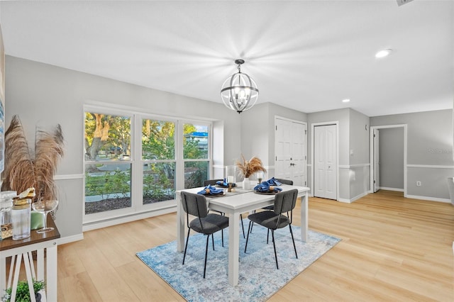 dining room featuring light wood finished floors, a notable chandelier, recessed lighting, and baseboards