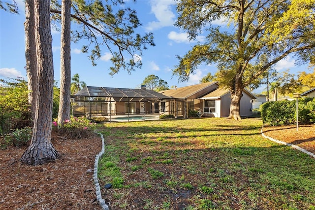 view of yard featuring glass enclosure and an outdoor pool