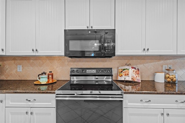 kitchen with electric stove, dark stone countertops, white cabinets, black microwave, and decorative backsplash