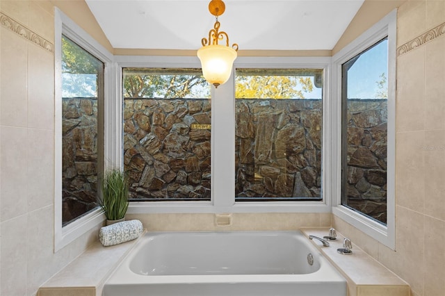 bathroom featuring a garden tub and vaulted ceiling