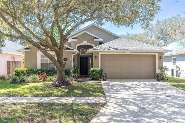 ranch-style house featuring a garage, fence, driveway, roof with shingles, and stucco siding