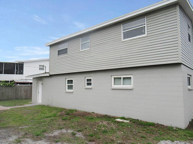 view of side of property featuring a yard and fence