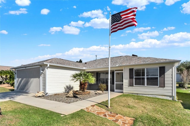 ranch-style house featuring a garage, roof with shingles, and a front yard