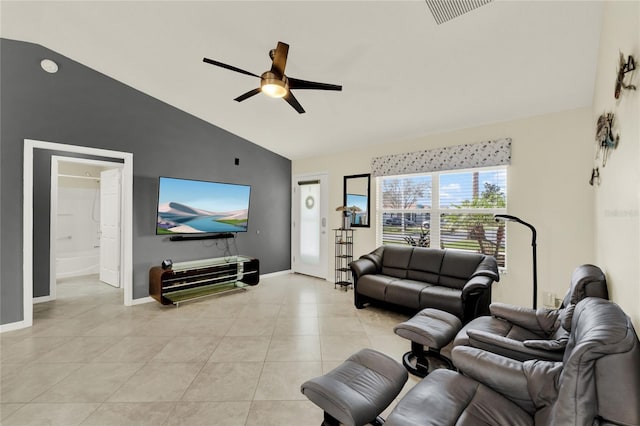 living area with light tile patterned flooring, a ceiling fan, visible vents, vaulted ceiling, and baseboards