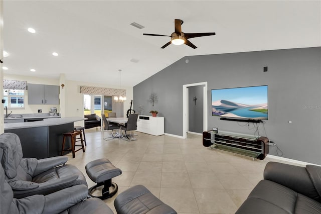 living room featuring visible vents, light tile patterned flooring, vaulted ceiling, baseboards, and ceiling fan with notable chandelier
