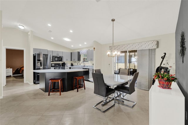 dining room featuring vaulted ceiling, recessed lighting, light tile patterned flooring, and an inviting chandelier