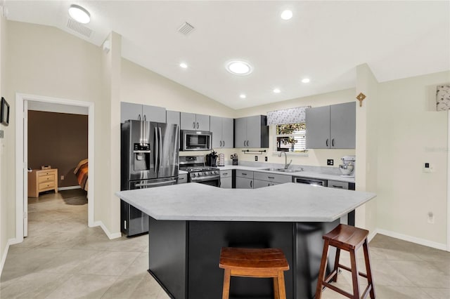 kitchen featuring lofted ceiling, stainless steel appliances, a sink, and visible vents