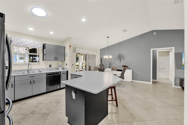 kitchen with gray cabinetry, a sink, a center island, dishwasher, and decorative light fixtures