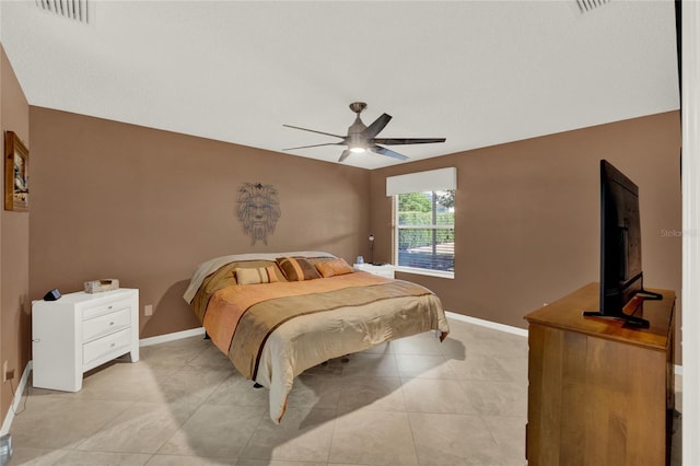 bedroom featuring light tile patterned floors, ceiling fan, visible vents, and baseboards