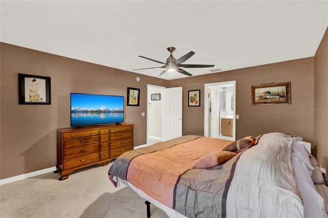 bedroom featuring ensuite bathroom, a ceiling fan, and baseboards