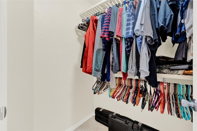 spacious closet with tile patterned floors
