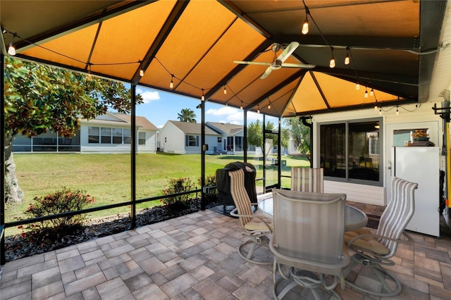 view of patio featuring a gazebo, outdoor dining space, and a residential view