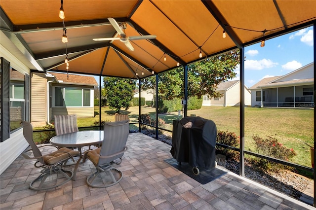 sunroom / solarium featuring lofted ceiling and a ceiling fan