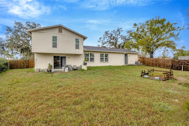 rear view of property featuring a fenced backyard, central AC unit, and a lawn