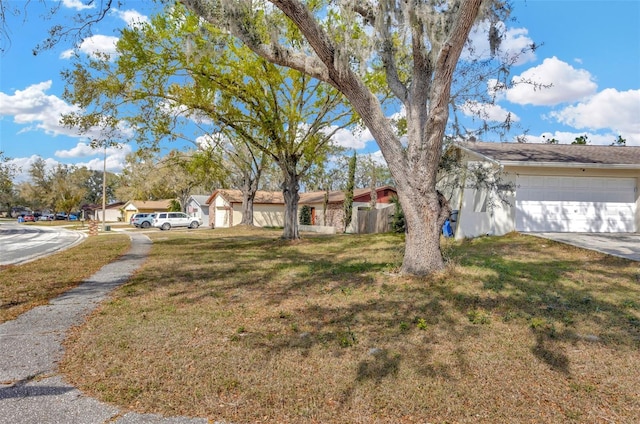 view of front of property with an attached garage, driveway, and a front yard