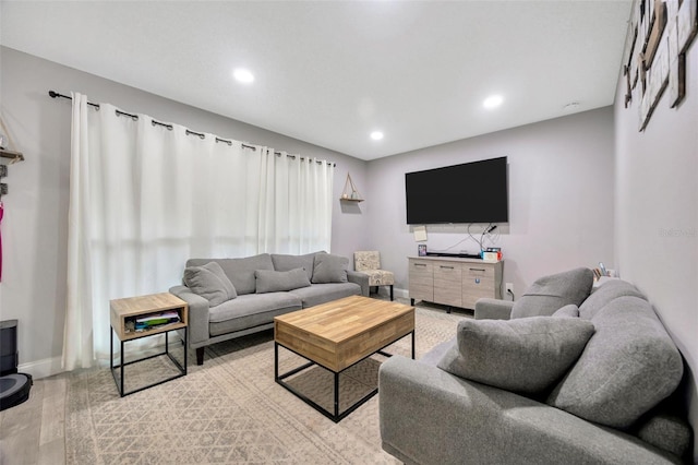 living area with light wood finished floors, recessed lighting, and baseboards