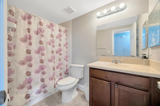 full bath with a shower with curtain, visible vents, vanity, and toilet