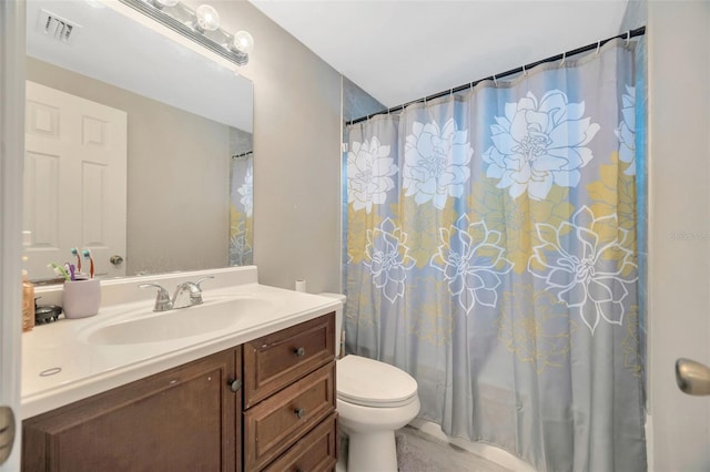 bathroom with toilet, visible vents, and vanity