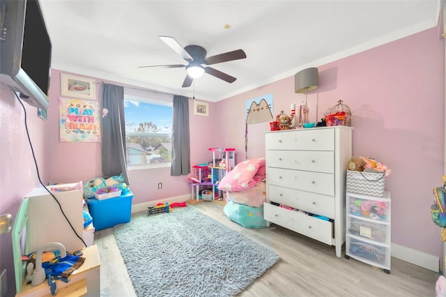 rec room featuring ceiling fan, baseboards, and wood finished floors