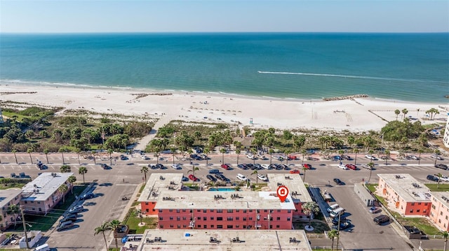 drone / aerial view with a water view and a beach view