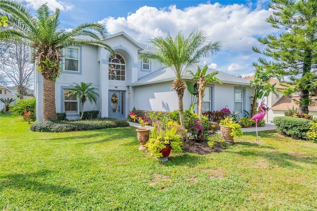 view of front of property featuring a front yard and stucco siding