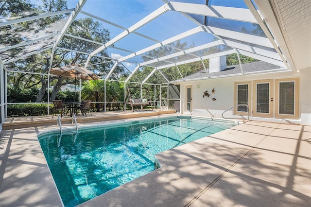 outdoor pool featuring a patio and a lanai