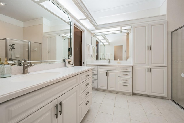 bathroom with ornamental molding, a stall shower, tile patterned flooring, and vanity