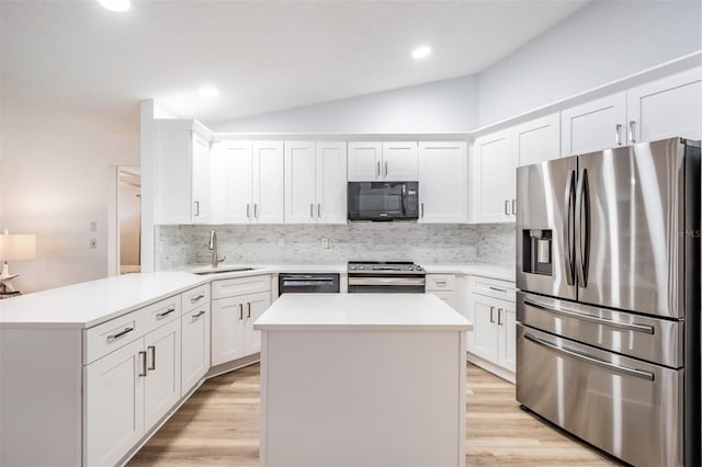 kitchen with light countertops, white cabinetry, a sink, a peninsula, and black appliances