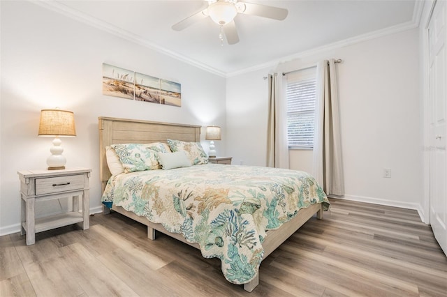 bedroom featuring baseboards, ornamental molding, and wood finished floors