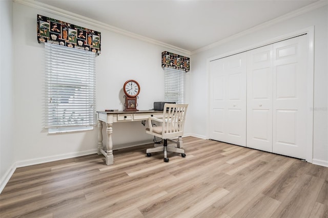 office space with ornamental molding, light wood-style floors, and baseboards