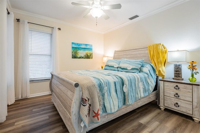 bedroom featuring visible vents, dark wood finished floors, baseboards, ceiling fan, and ornamental molding