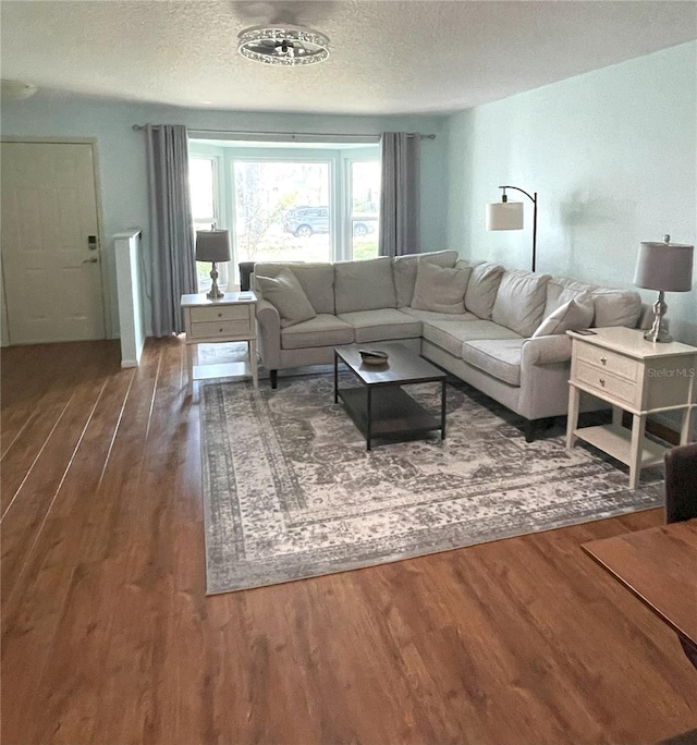 living area featuring a textured ceiling and wood finished floors