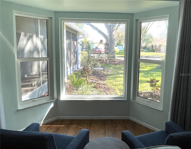 interior space with wood finished floors and baseboards