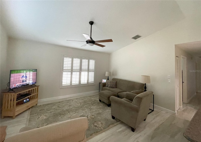 living room with lofted ceiling, ceiling fan, visible vents, and baseboards