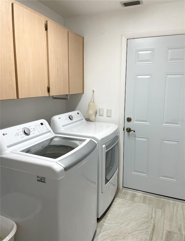 laundry room with washer and dryer and cabinet space