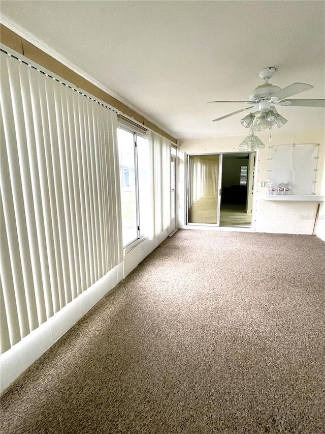 unfurnished sunroom with a ceiling fan