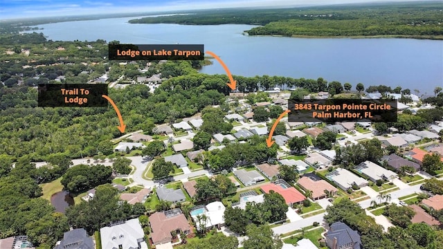 birds eye view of property with a water view and a residential view