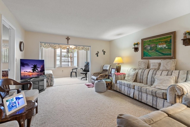 carpeted living area featuring a notable chandelier