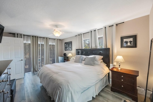 bedroom featuring ceiling fan, access to outside, and wood finished floors